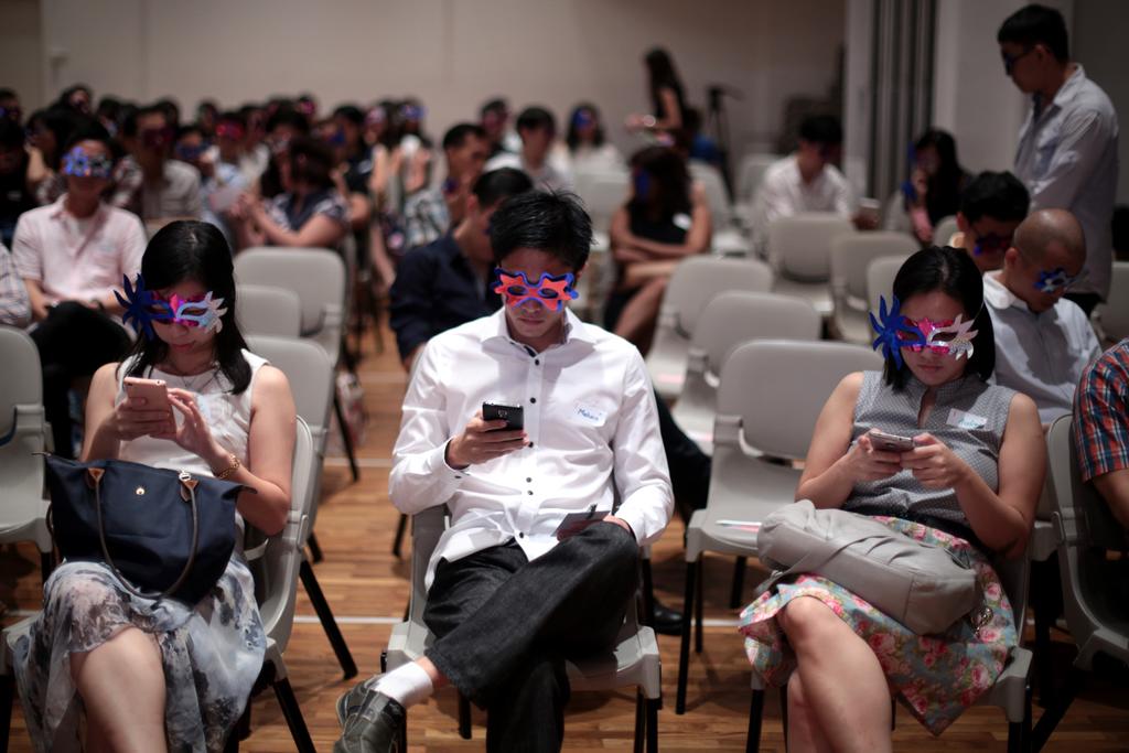 Participants of a mass speed dating event in February 2016 using their mobile phones and wearing masks to help self-conscious singles step out of their comfort zone. u00e2u20acu2022 TODAY file pic