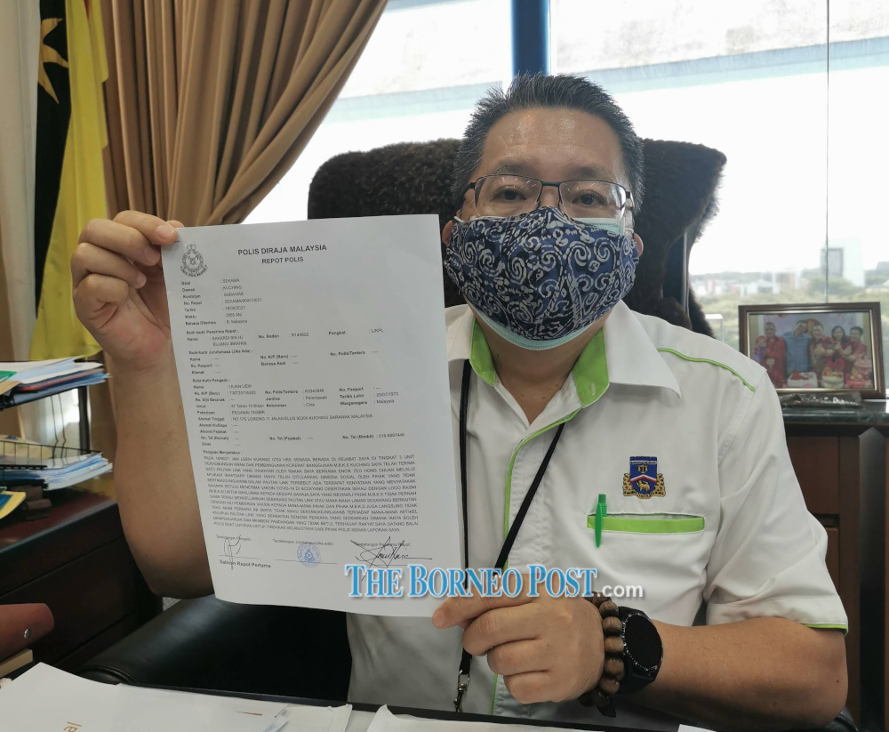 Kuching South mayor Datuk Wee Hong Seng shows the police report. u00e2u20acu201d Borneo Post Online pic 