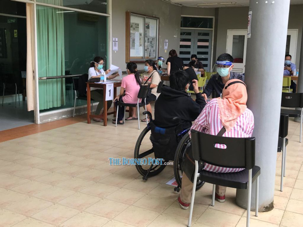 Those registered await vaccination at the Agape Centre. u00e2u20acu201d Borneo Post Online pic 