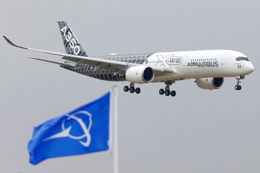 An Airbus A350 jetliner flies over Boeing flags as it lands after a flying display during the 51st Paris Air Show at Le Bourget airport near Paris, June 15, 2015. u00e2u20acu201d Reuters pic