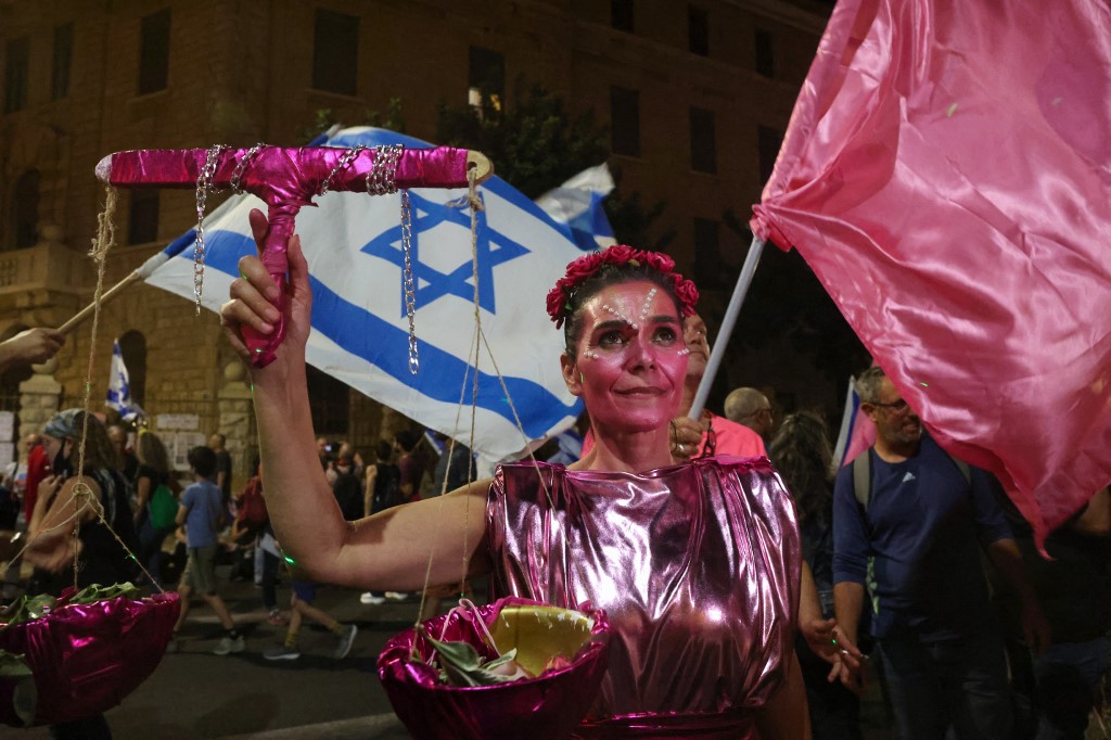 An Israeli protester dressed as lady justice looks on during a demonstration against Prime Minister Benjamin Netanyahu in front of his residence in Jerusalem, on June 12, 2021, a day ahead of a vote on a new government at the Knesset. u00e2u20acu201d AFP pic