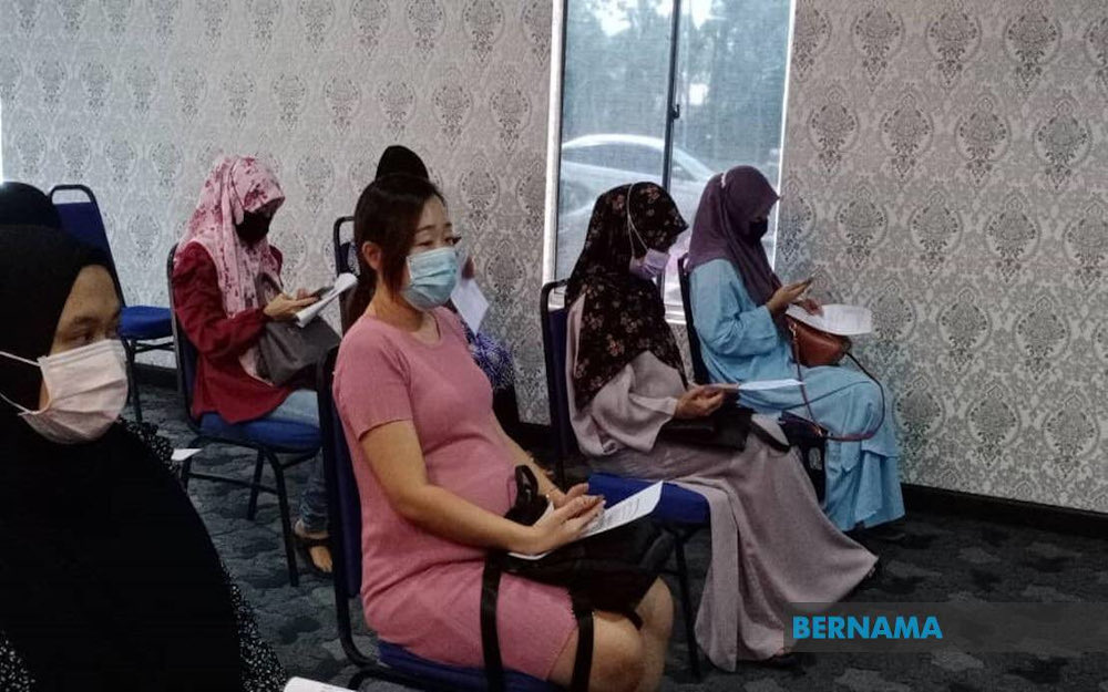 Expectant mothers in Perlis waiting to receive their first dose of the Pfizer-BioNTech Covid-19 vaccine jab at the Dewan 2020 vaccination centre June 27, 2021. u00e2u20acu201d Picture via Twitter/Bernama