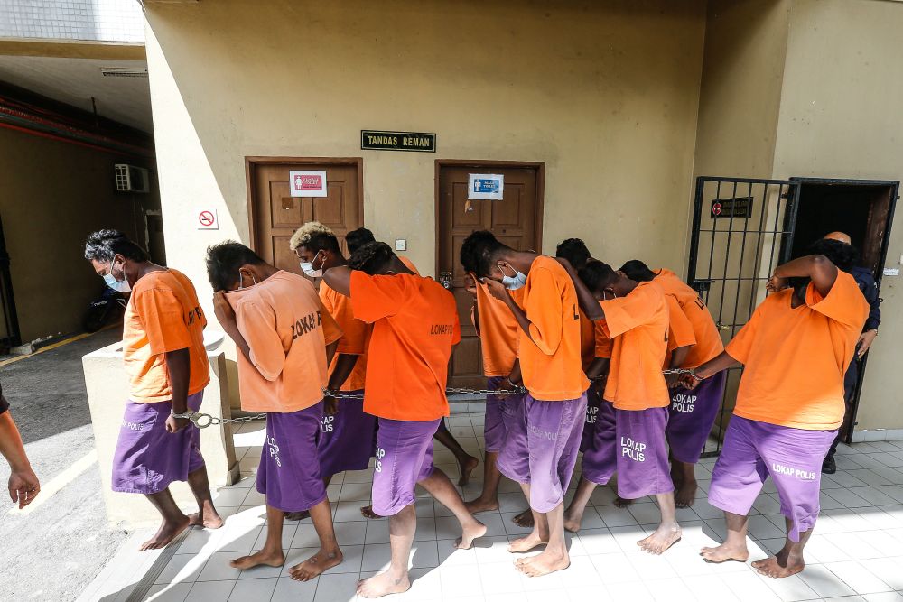 A group of youths who flouted the MCO SOPs by taking part in a funeral procession arrive at the Butterworth Court Complex June 21, 2021. u00e2u20acu201d Picture by Sayuti Zainudin