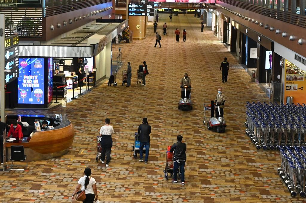 People walking along the transit hall at Changi International Airport in Singapore in January 2021. u00e2u20acu201d AFP pic