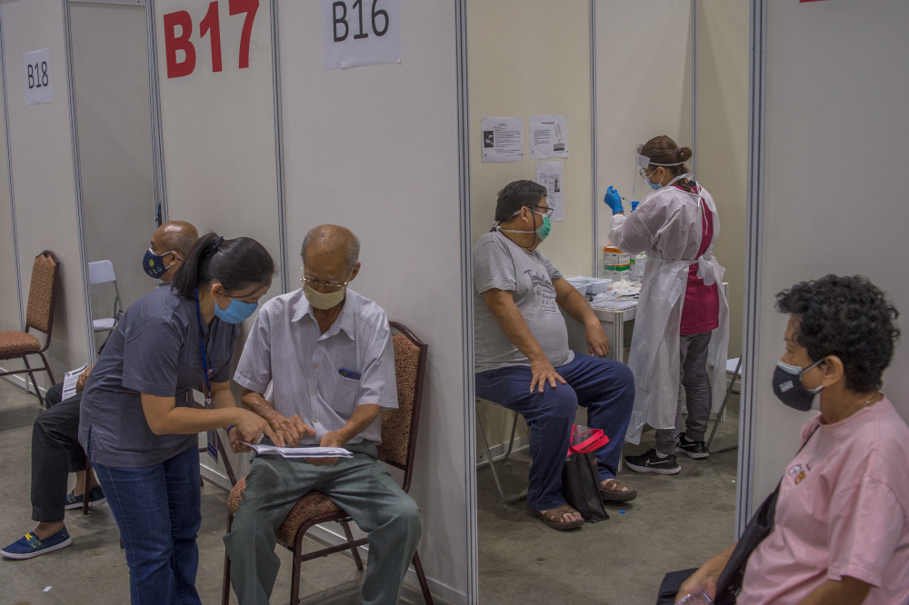 People receive their Covid-19 vaccines during the National Covid-19 Immunisation Programme at Kuala Lumpur Convention Centre in Kuala Lumpur June 8, 2021. u00e2u20acu201d Picture by Shafwan Zaidon