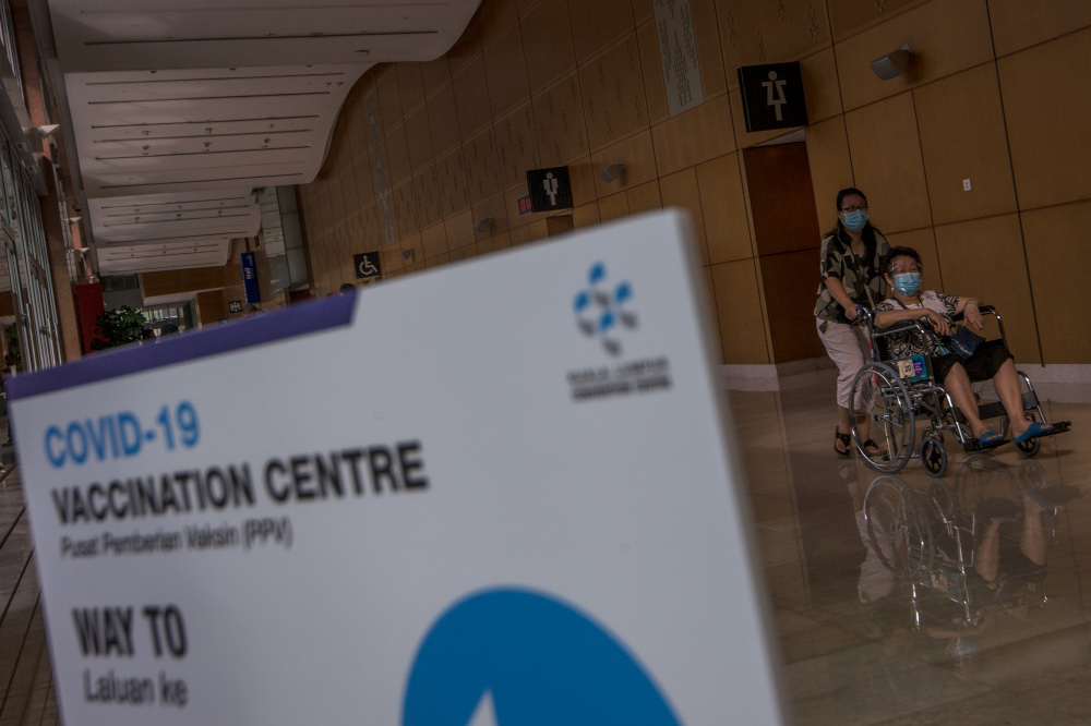 A vaccine recipient being taken to the vaccination centre at the Kuala Lumpur Convention Centre, June 8, 2021. u00e2u20acu201d Picture by Shafwan Zaidon