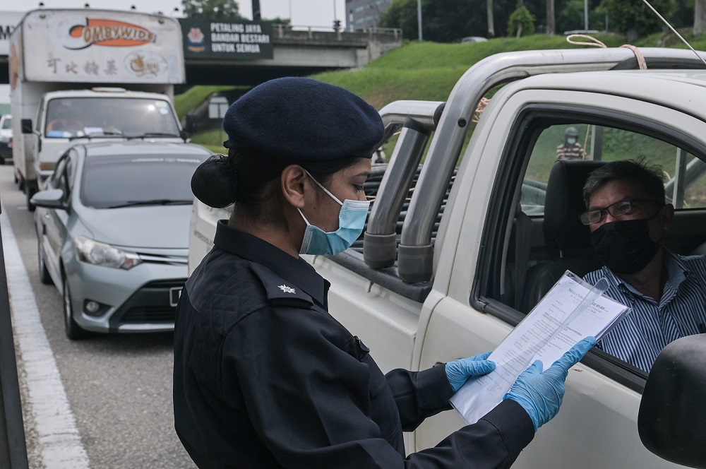 A police personnel mans a roadblock in Damansara June 3, 2021. u00e2u20acu2022 Picture by Miera Zulyana