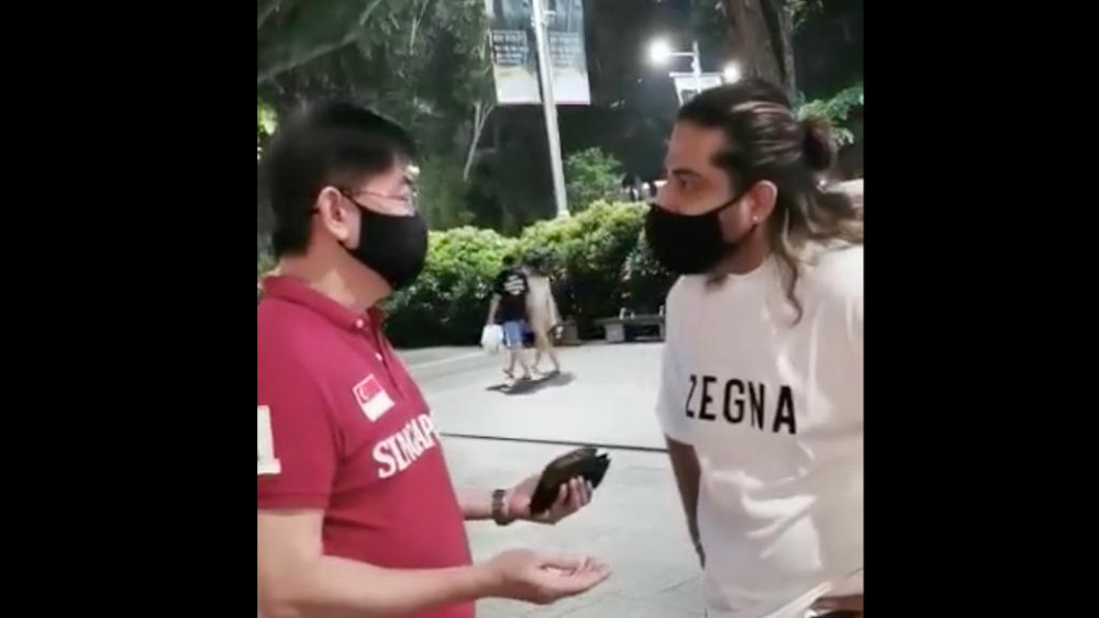 Screenshot of the video showing Dave Parkash (right) being confronted by a man. u00e2u20acu201d Picture via Facebook/Dave Park Ash