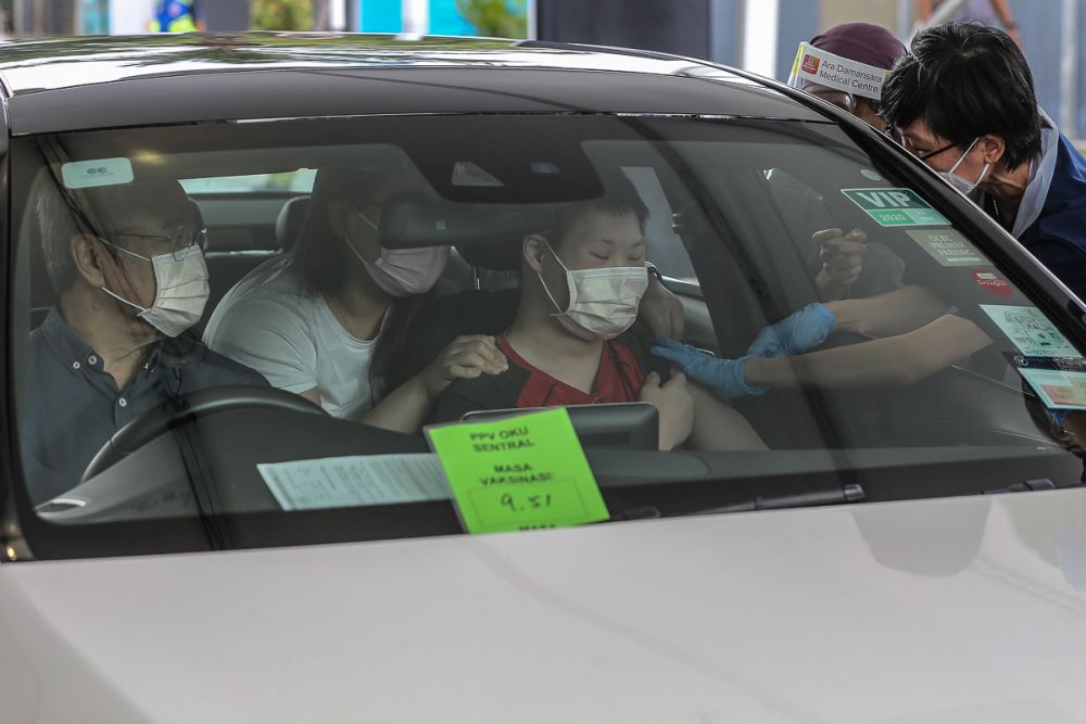 nThe disabled receive their Covid-19 jabs at Menara Sime Darby Plantation in Ara Damansara June 4, 2021. u00e2u20acu201d Picture by Yusof Mat Isan