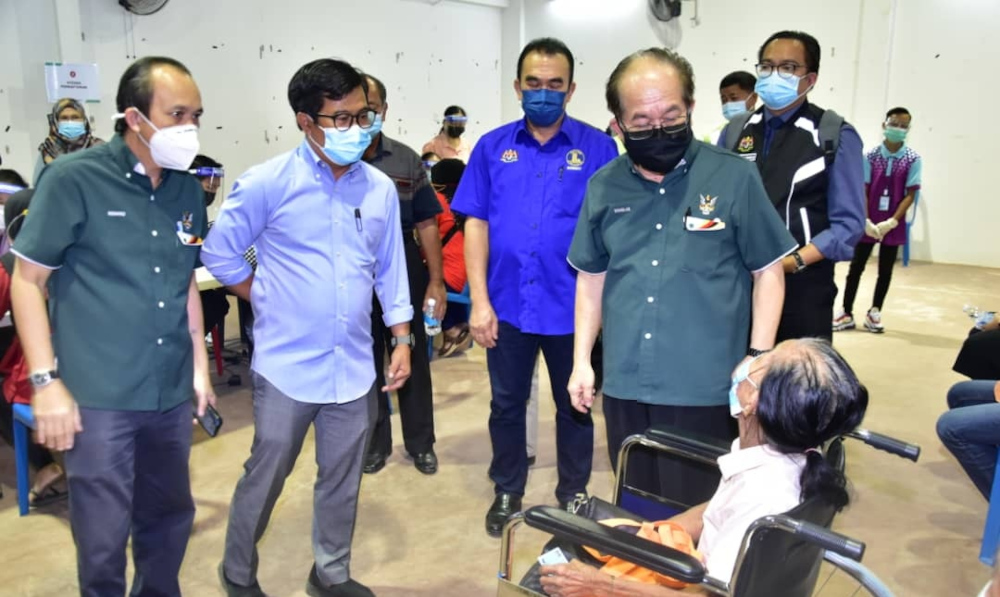Deputy Chief Minister Datuk Amar Douglas Uggah having a chat with a senior citizen who is waiting for his turn to be vaccinated at Spaoh Community Hall, June 23, 2021. u00e2u20acu201d Picture courtesy of the Deputy Chief Ministeru00e2u20acu2122s Office