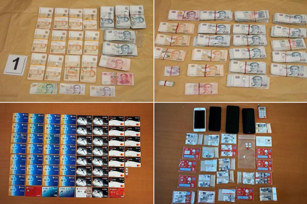 Cash, bank cards, phones and other items seized by the police in Singapore as part of a joint operation with Hong Kong police. u00e2u20acu201d Picture courtesy of SPF via TODAY