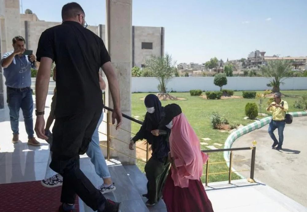Members of Kurdish security forces accompany relatives of Islamic State group fighters before handing them over to a delegation of Dutch diplomats in Syriau00e2u20acu2122s northeastern city of Qamishli. u00e2u20acu201d AFP pic