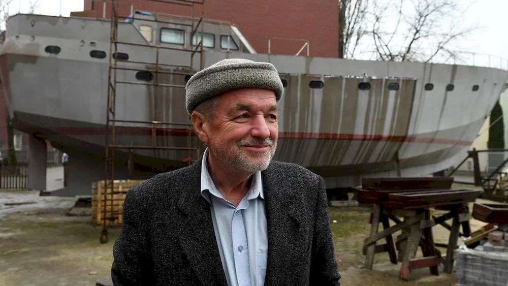 Ship Captain Waldemar Rzeznicki stands in front of a steel schooner called u00e2u20acu02dcFather Boguslawu00e2u20acu2122 under construction at the courtyard of a homeless shelter run by Catholic Fathers in Warsaw on March 27, 2021. u00e2u20acu201d AFP pic