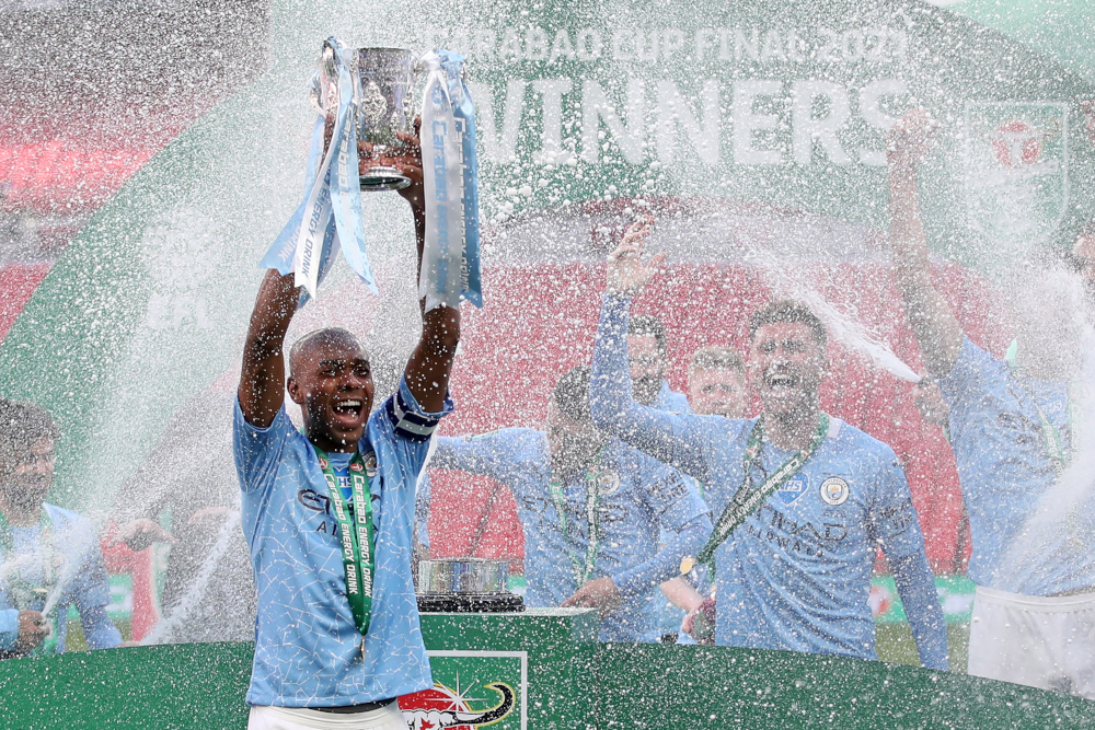 Manchester Cityu00e2u20acu2122s Brazilian midfielder Fernandinho lifts the winners trophy after the English League Cup final football match between Manchester City and Tottenham Hotspur at Wembley Stadium, London April 25, 2021. u00e2u20acu201d AFP pic 