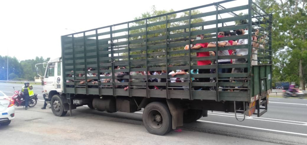 It was reported that police detained a lorry with 48 workers on board who were positive Covid-19 and wearing pink bracelets in Sungai Lalang, Bedong yesterday. Pictures of the incident went viral on social media. u00e2u20acu201d Picture from Facebook/Polis Daerah Kua