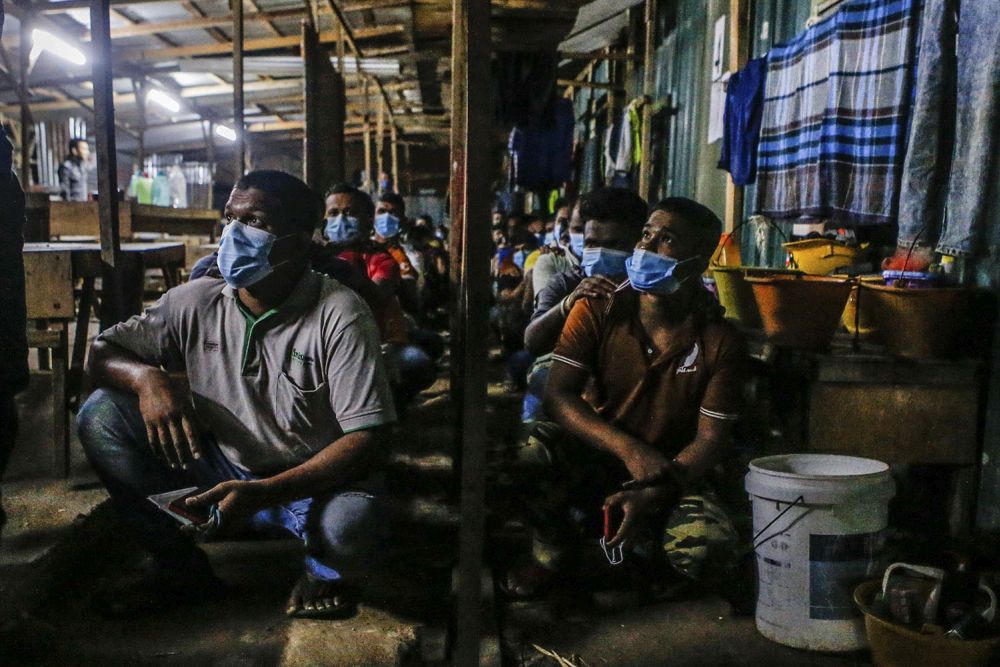 Immigration Department personnel round up foreign workers during a raid on a construction site in Southville City, Dengkil June 20, 2021. u00e2u20acu201d Picture by Hari Anggara