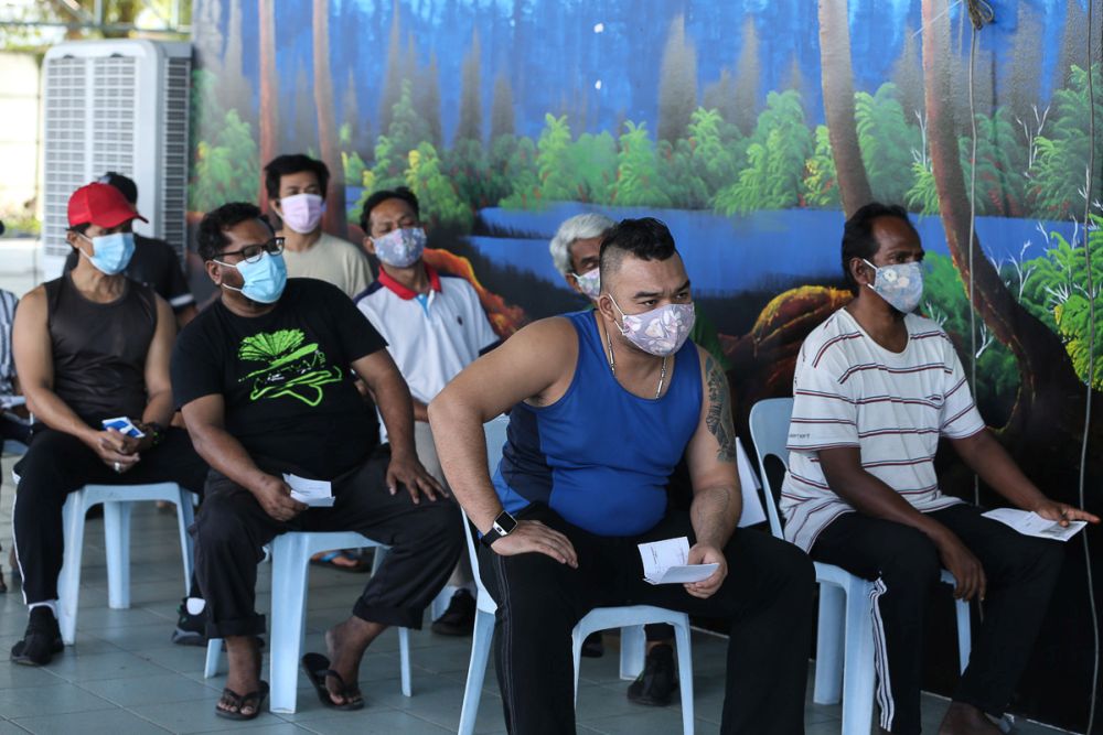 The homeless wait to receive the second dose of their Covid jab at Anjung Kelana, Kuala Lumpur June 17, 2021. u00e2u20acu2022 Picture by Yusof Mat Isa