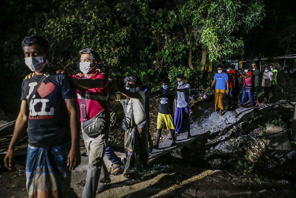 Immigration Department personnel round up foreign workers during a raid on a construction site in Cyberjaya June 6, 2021. u00e2u20acu201d Picture by Hari Anggara