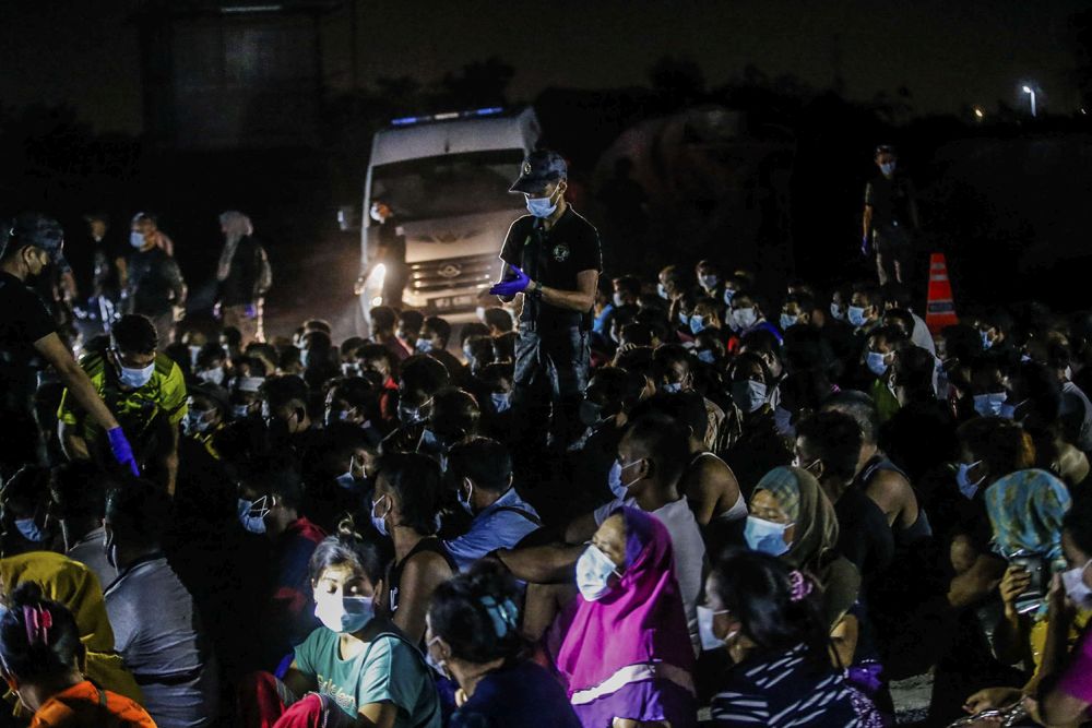 Immigration Department personnel round up foreign workers during a raid on a construction site in Cyberjaya June 6, 2021. u00e2u20acu201d Picture by Hari Anggara