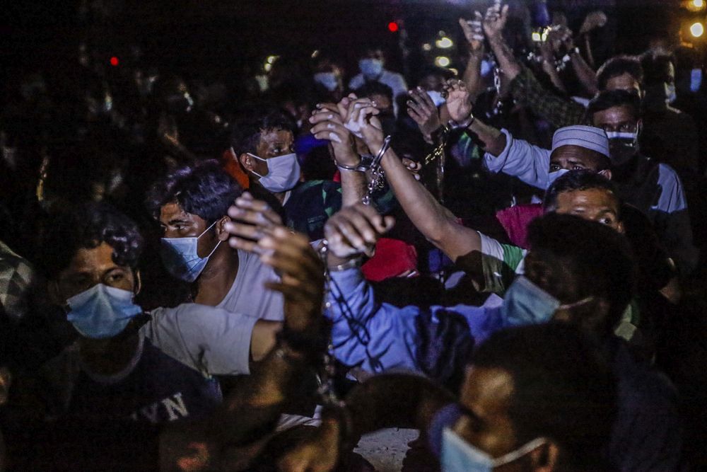 Immigration Department personnel round up foreign workers during a raid on a construction site in Cyberjaya June 6, 2021. u00e2u20acu201d Picture by Hari Anggara