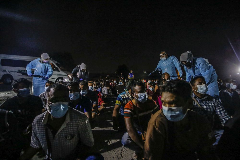Immigration Department spray disinfectant on foreign workers during a raid on a construction site in Cyberjaya June 6, 2021. u00e2u20acu201d Picture by Hari Anggara