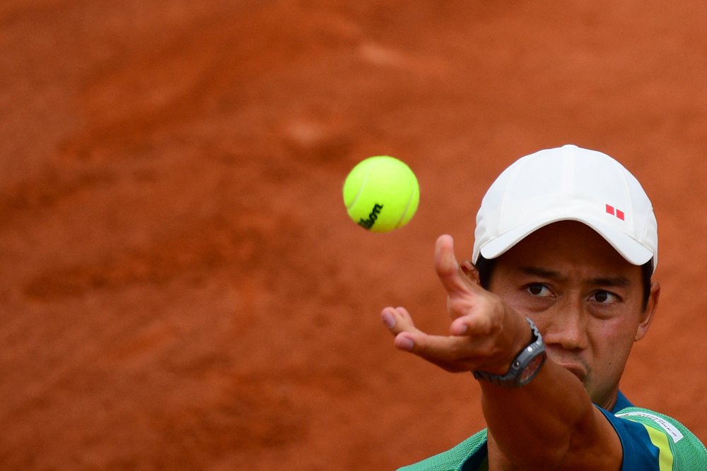 Japanu00e2u20acu2122s Kei Nishikori eyes the ball as he serves to Switzerlandu00e2u20acu2122s Henri Laaksonen during their menu00e2u20acu2122s singles third round tennis match on Day 6 of The Roland Garros 2021 French Open tennis tournament in Paris June 4, 2021. u00e2u20acu201d AFP picnn