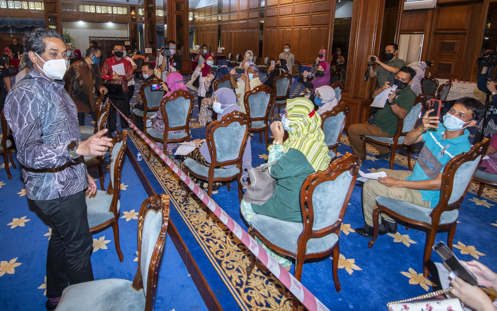 National Covid-19 Immunisation Programme Coordinating Minister Khairy Jamaluddin speaking with vaccine recipients while visiting the Kota Darulnaim Complex vaccination centre in Kota Baru, June 17, 2021. u00e2u20acu201d Bernama 