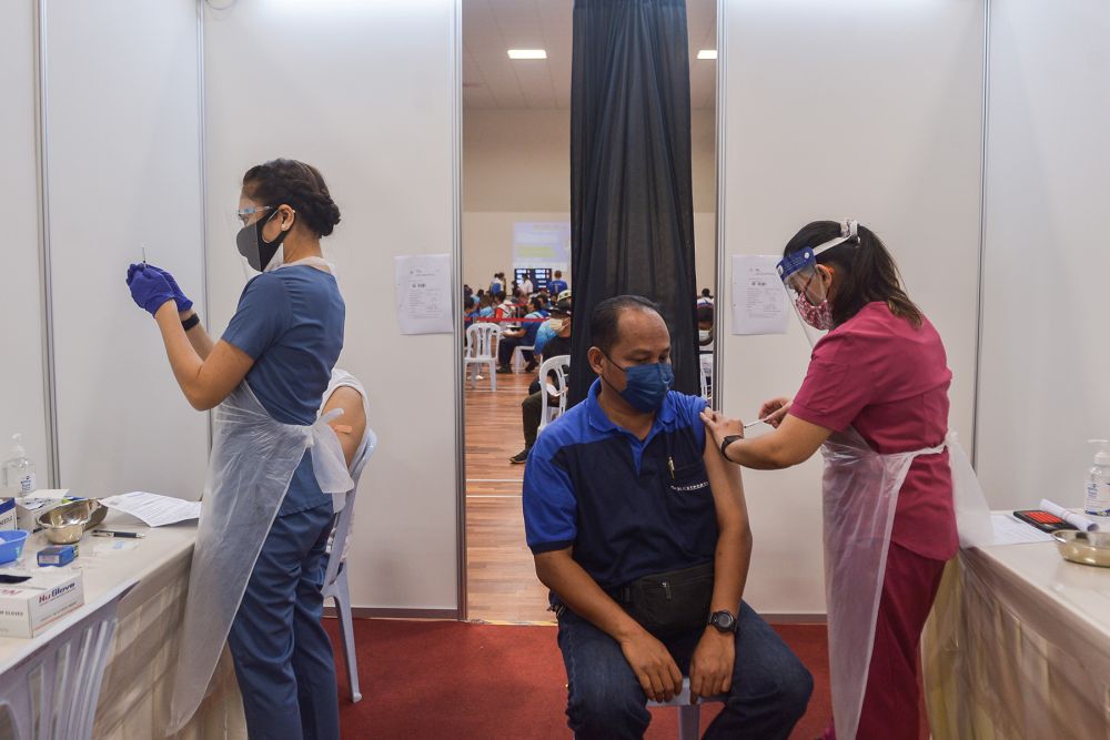 Transportation personnel receive their Covid-19 jab at the Port Klang Sport Clubu00e2u20acu2122s multipurpose hall June 25, 2021. u00e2u20acu201d Picture by Miera Zulyana