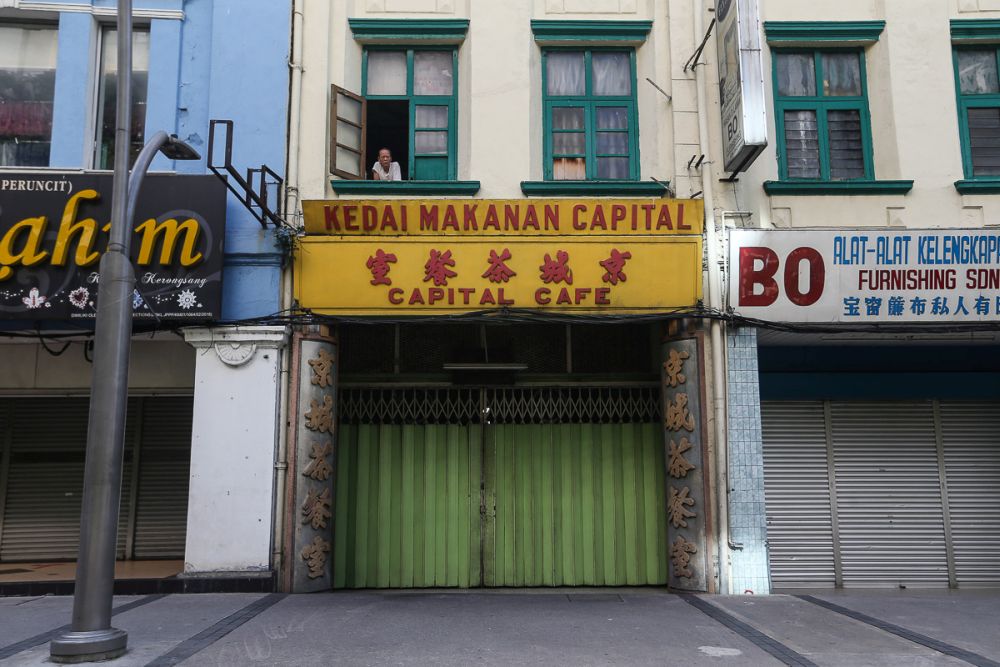 A man looks out of the window from a shoplot in Kuala Lumpur as the 14-day u00e2u20acu02dctotal lockdownu00e2u20acu2122 commenced June 1, 2021. u00e2u20acu201d Picture by Yusof Mat Isa