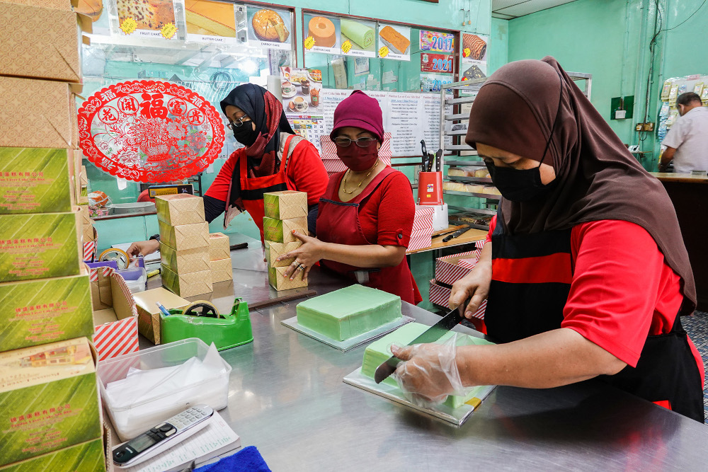 Workers of Pandan Layer Bakery busy preparing their signature pandan layer cake for customers during the movement control order 3.0 (MCO 3.0) in Klang June 23, 2021. u00e2u20acu201d Picture by Miera Zulyana