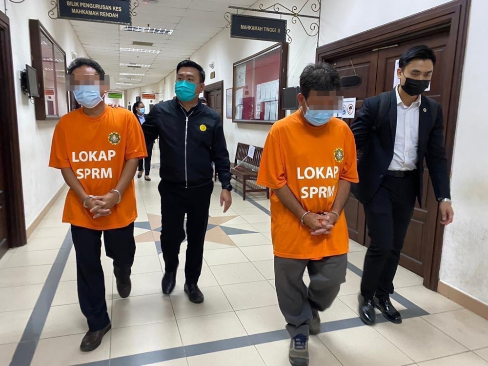 The two suspects leave the courtroom after they were ordered to be remanded until Monday. u00e2u20acu201d Borneo Post Online pic