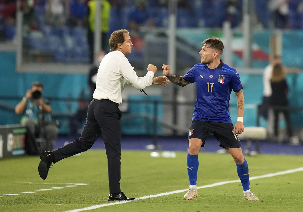Italy's Ciro Immobile celebrates with coach Roberto Mancini after scoring the third goal against Switzerland June 17, 2021. u00e2u20acu2022 Pool via Reuters
