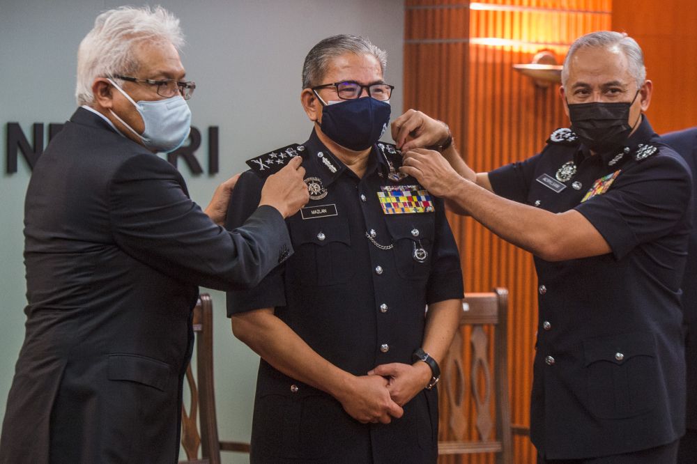 Home Minister Datuk Seri Hamzah Zainudin, newly appointed deputy IGP Datuk Seri Mazlan Lazim and IGP Datuk Seri Acryl Sani Abdullah Sani pose for the cameras during the rank conferment ceremony in Putrajaya, June 25, 2021. u00e2u20acu201d Picture by Shafwan Zaidon
