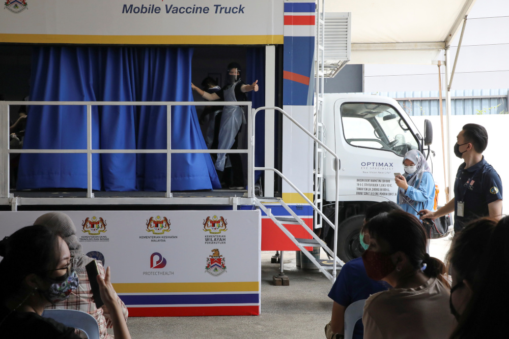 A medical worker gestures inside a coronavirus disease (Covid-19) vaccination truck in Kuala Lumpur, Malaysia June 8, 2021. u00e2u20acu201d Reuters  pic 