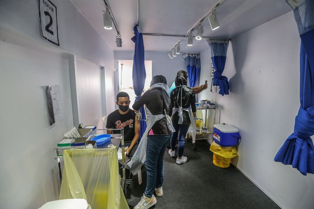 People receive their Covid-19 vaccination through the MYMedic@Wilayah Vaccine Mobile Truck programme at PPR Seri Alam in Kuala Lumpur June 23, 2021. u00e2u20acu201d Picture by Yusof Mat Isa