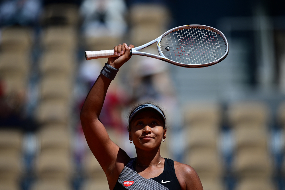 Japanu00e2u20acu2122s Naomi Osaka celebrates after winning against Romaniau00e2u20acu2122s Patricia Maria Tig during their womenu00e2u20acu2122s singles first round tennis match on Day 1 of The Roland Garros 2021 French Open tennis tournament in Paris May 30, 2021. u00e2u20acu201d AFP picnn