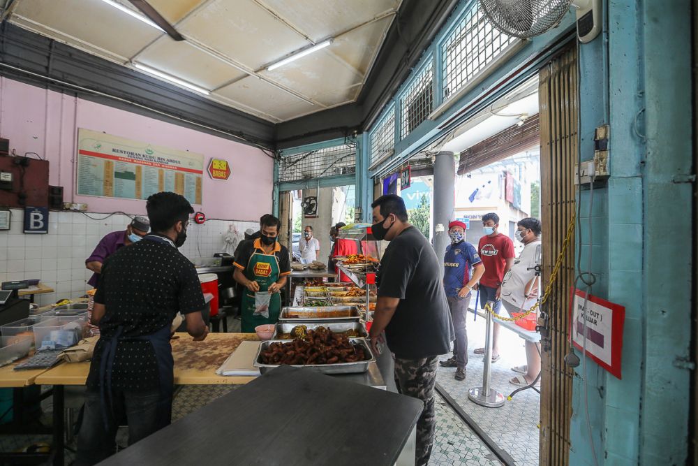 Members of the public queue to pack food at Restoran Kudu bin Abdul in Kuala Lumpur June 14, 2021. u00e2u20acu201d Picture by Yusof Mat Isa