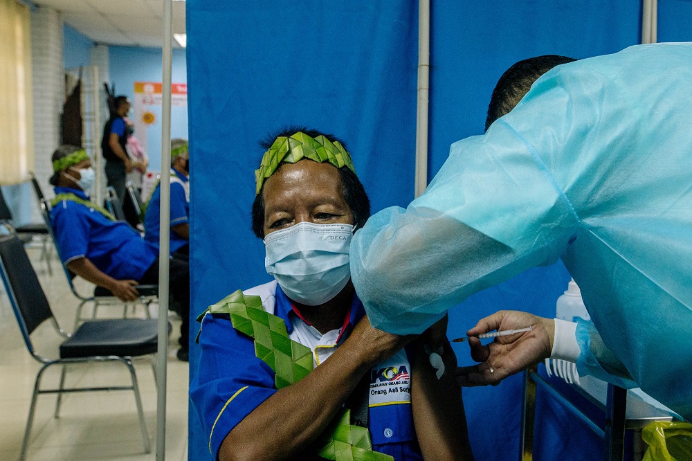 A man from the Orang Asli community receives a dose of the Covid-19 vaccine in Gombak June 19, 2021. u00e2u20acu2022 Picture by Firdaus Latif