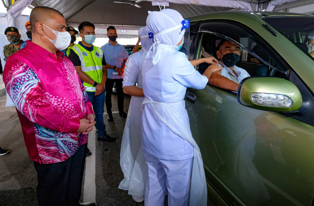 Perak Mentri Besar Datuk Saarani Mohamad observes the drive-through vaccination process at Indera Mulia Stadium in Ipoh, June 10, 2021. u00e2u20acu201d Bernama pic 