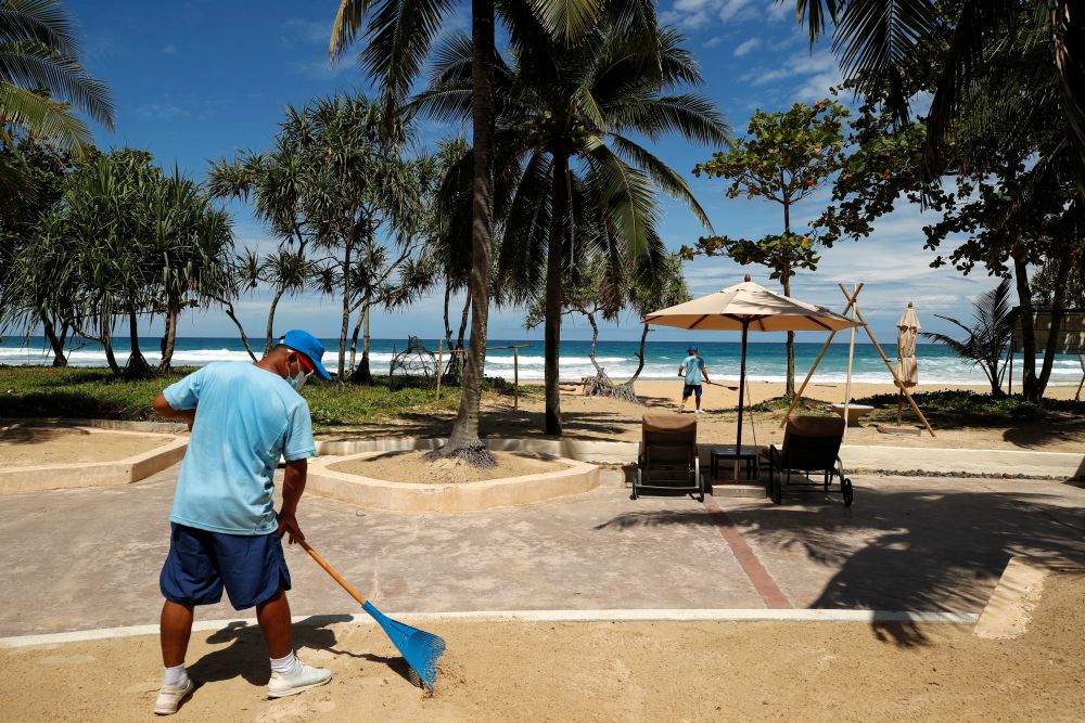 A man rakes the sand on a beach as Phuket gets ready to open to overseas tourists from July 1 allowing fully vaccinated foreigns to visit the resort island without quarantine June 29, 2021. u00e2u20acu2022 Reuters picnn