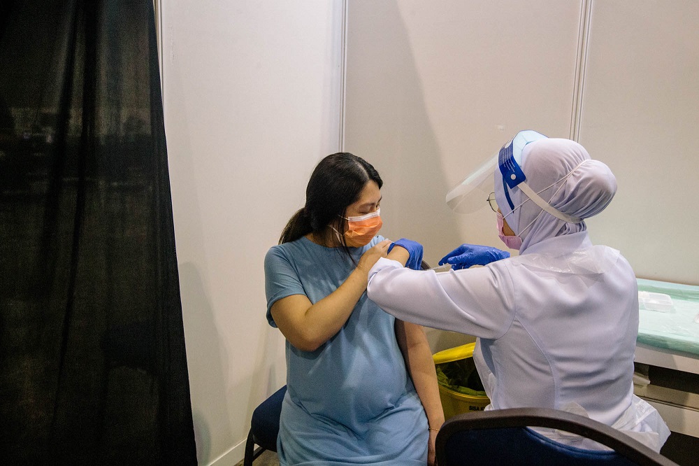 A pregnant woman receives a dose of a Covid-19 vaccine at the Mitec vaccination centre in Kuala Lumpur June 26, 2021. u00e2u20acu2022 Picture by Firdaus Latif