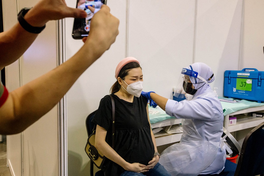 A pregnant woman receives a dose of a Covid-19 vaccine at the Mitec vaccination centre in Kuala Lumpur June 26, 2021. u00e2u20acu2022 Picture by Firdaus Latif