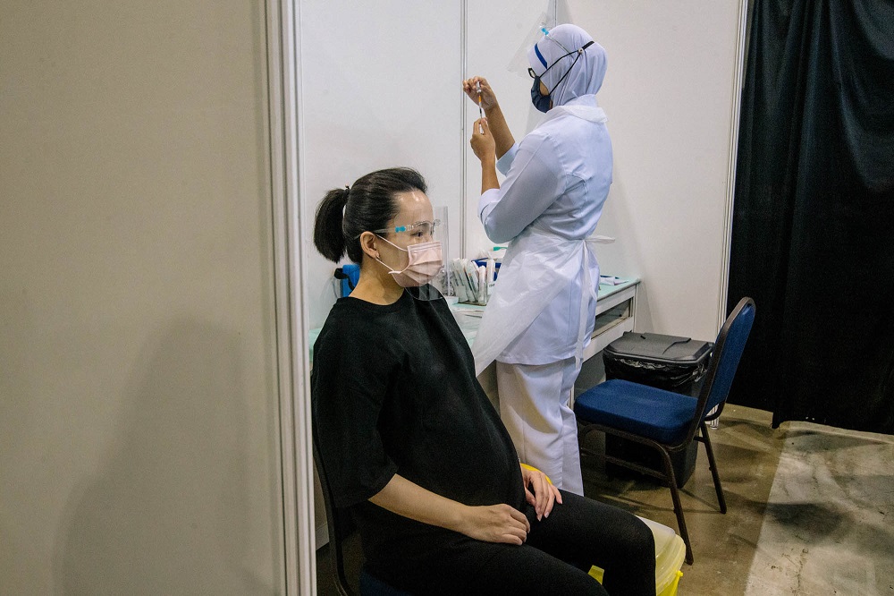A pregnant woman receives a dose of a Covid-19 vaccine at the Mitec vaccination centre in Kuala Lumpur June 26, 2021. u00e2u20acu2022 Picture by Firdaus Latif