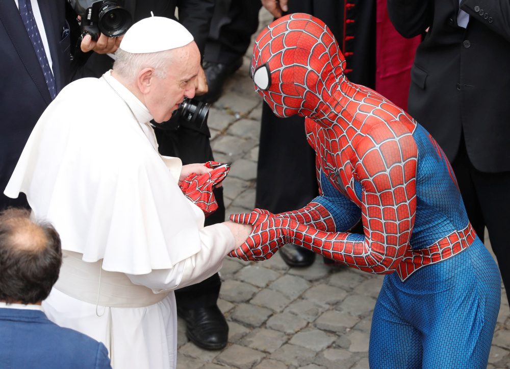 Pope Francis receives a Spiderman mask from a person dressed as Spiderman after the general audience, amid the coronavirus disease (Covid-19) pandemic, at the Vatican, June 23, 2021. u00e2u20acu201d Reuters pic