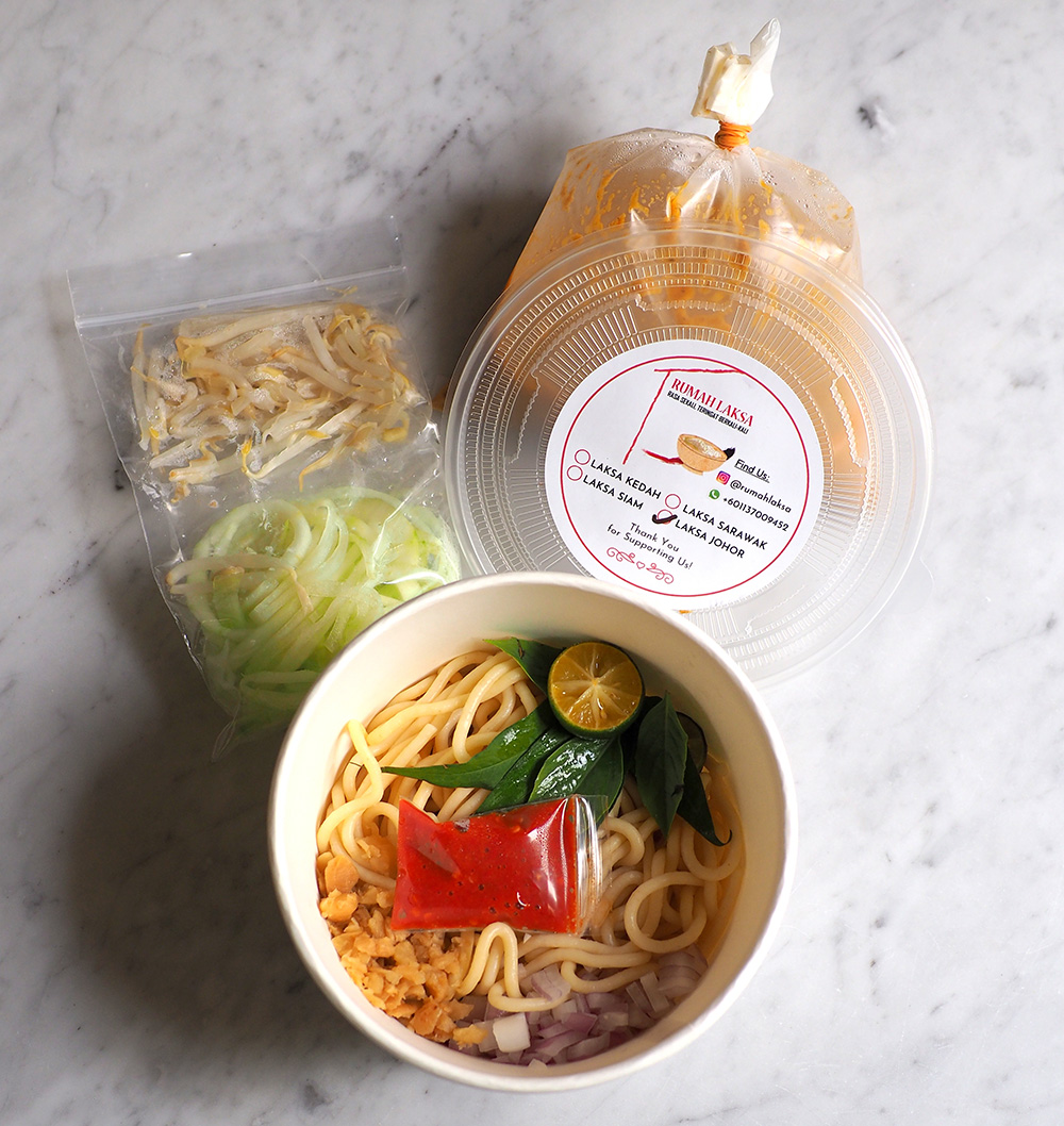 The condiments, pasta and broth are all neatly packed for the Johor laksa.