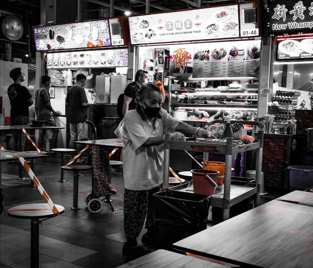 An elderly hawker centre cleaner in Singapore won over social media users for offering drinks to two patrons after seeing one of them sweating profusely from eating chilli ban mian. u00e2u20acu2022 Picture via Facebook/ Andrew Wong