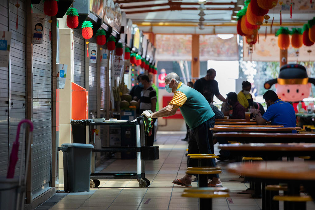 A cleaner working at Maxwell Food Centre on Feb 11, 2021. u00e2u20acu2022 TODAY pic