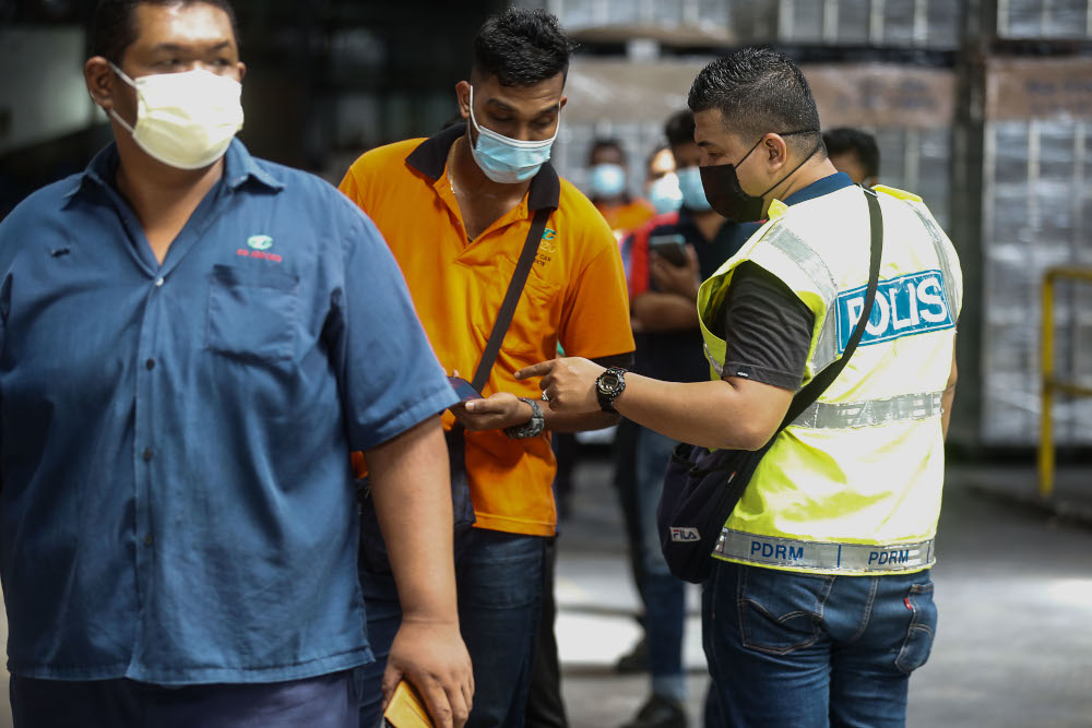 Enforcement officers conduct SOP spot checks on a factory in Mak Mandin, Penang, June 23, 2021. u00e2u20acu201d Picture by Sayuti Zainudin