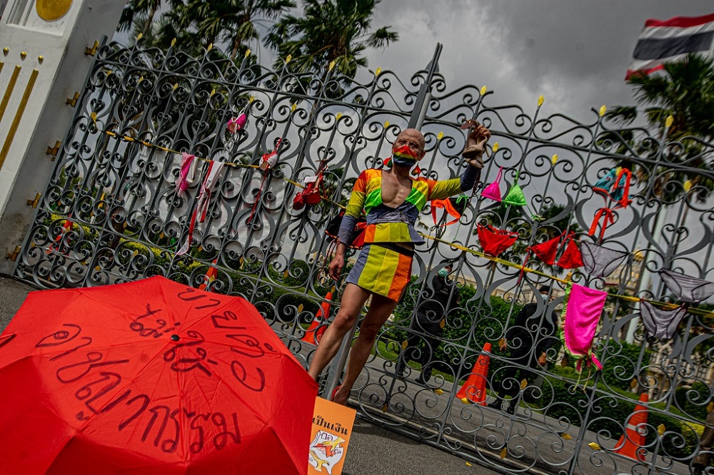 A protester stands in front of Thailandu00e2u20acu2122s Government House demanding for compensation during Covid-19 closures. u00e2u20acu2022 Picture via Facebook/iLaw