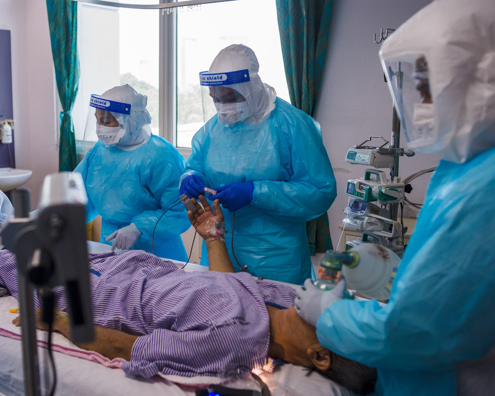 Healthcare workers perform the intubation procedure on a Covid-19 patient in Hospital Serdangu00e2u20acu2122s ICU. u00e2u20acu201d Picture by Shafwan Zaidon